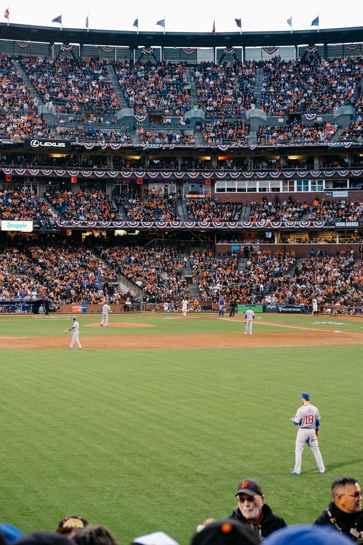 A baseball game in a large filled stadium