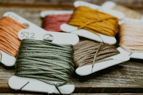 A pile of different colored embroidery string