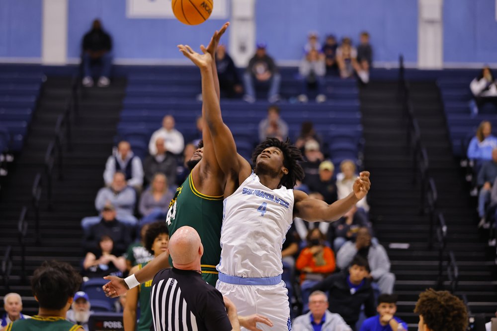 SSU Men's Basketball player Dillon Iyawe jumping for the ball