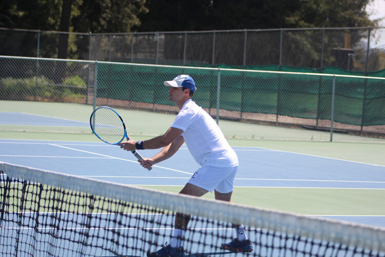 Student playing tennis 