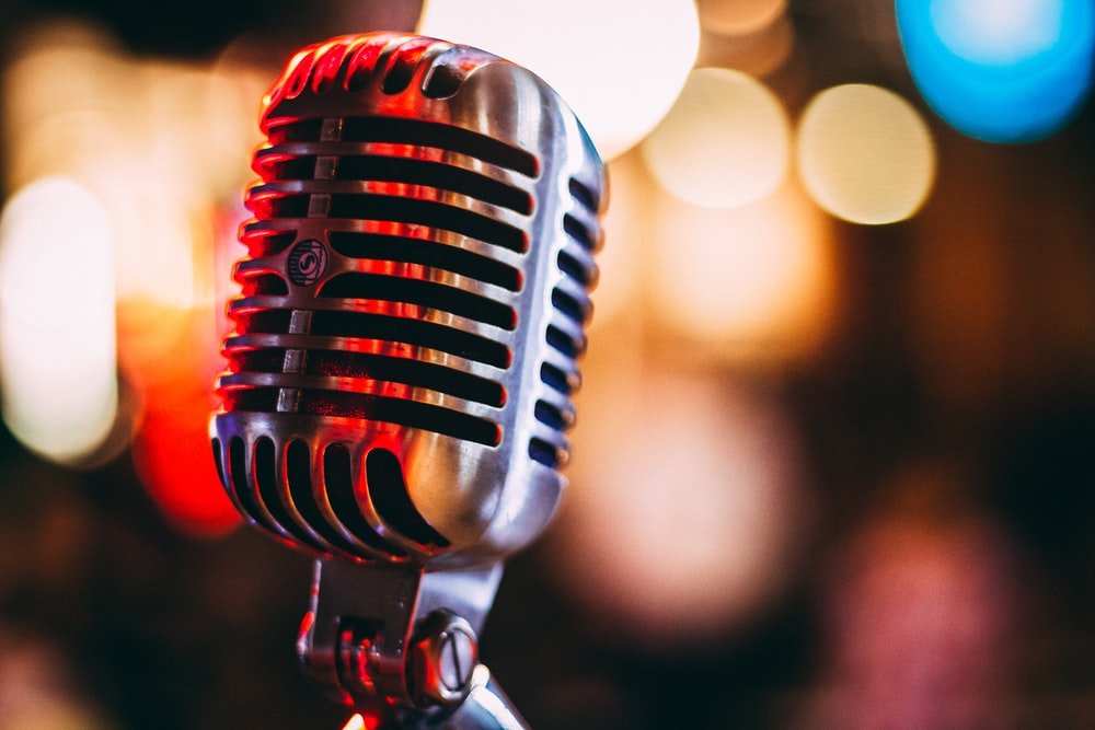 A microphone in front of a multi-colored bokeh background
