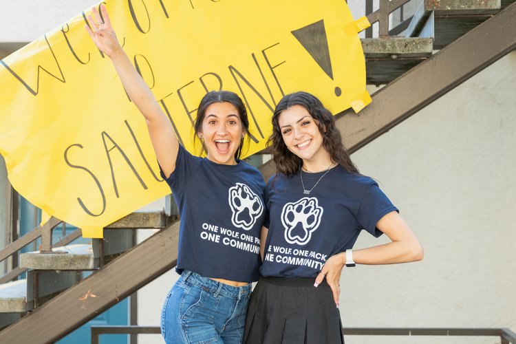 Two people posing in SSU shirts on Move In Day