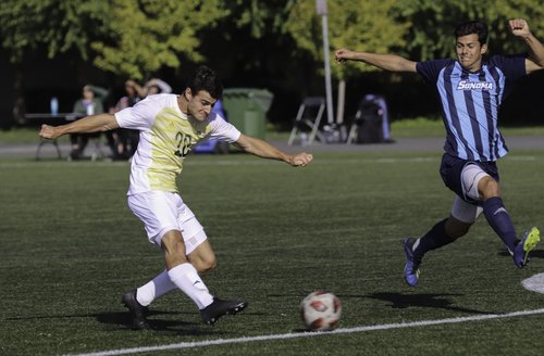 Student kicking a soccer ball 