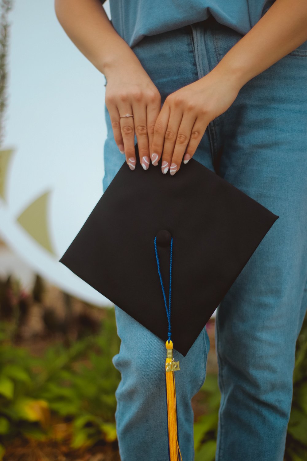 a person holding a graduation cap