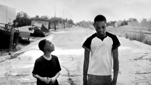 Two young people walking on an empty street