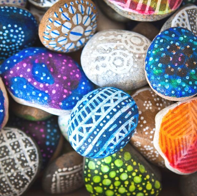 Stones painted with vibrant colors and patterns