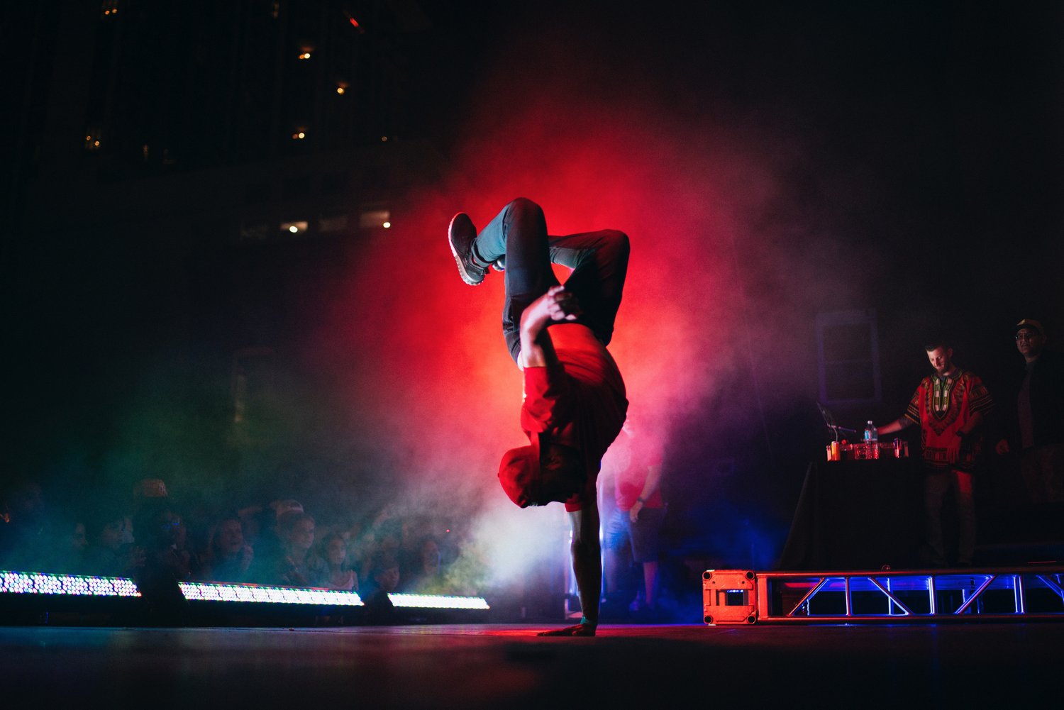 A performer doing a handstand on stage