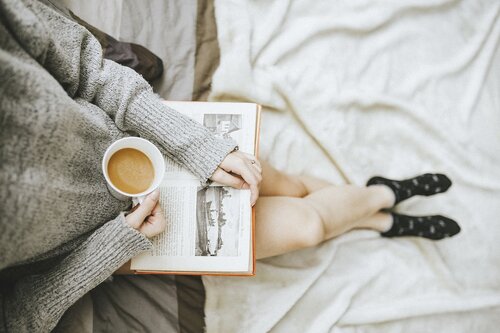 Person drinking coffee and reading 