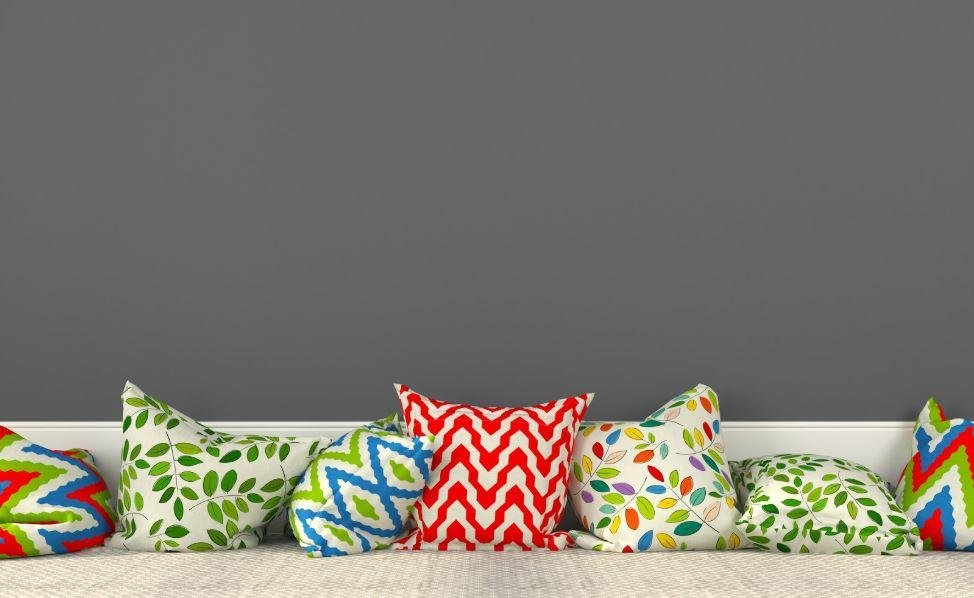 A row of multi-colored pillows with varying patterns 