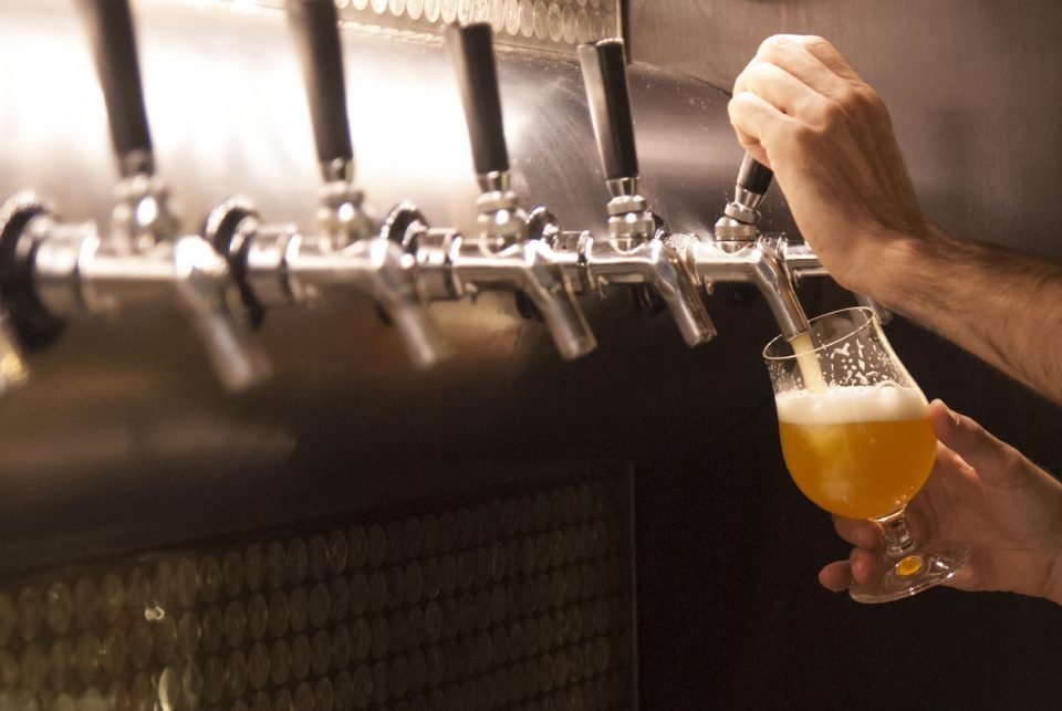 Someone pouring a beer from a tap