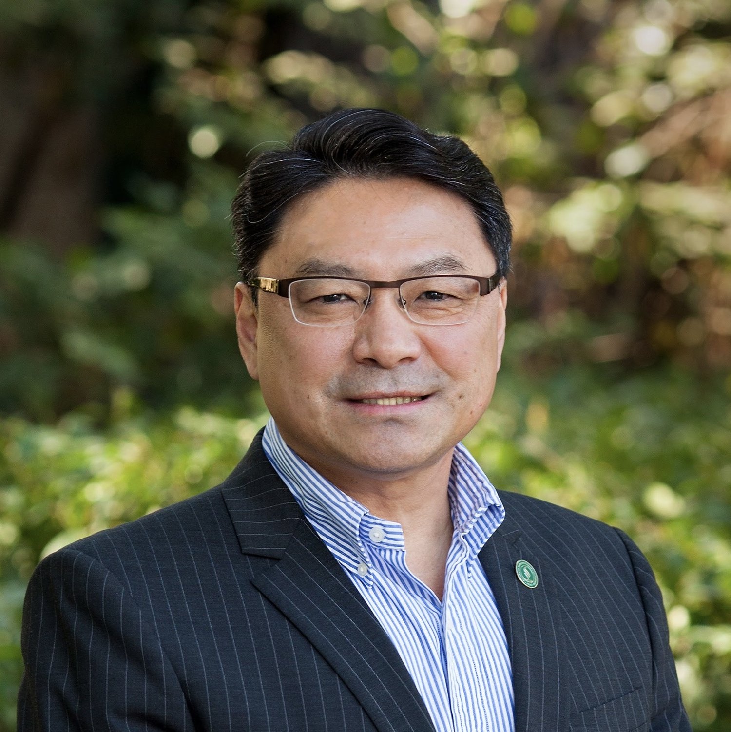 A portrait of Interim President Mike Lee in an outdoor setting