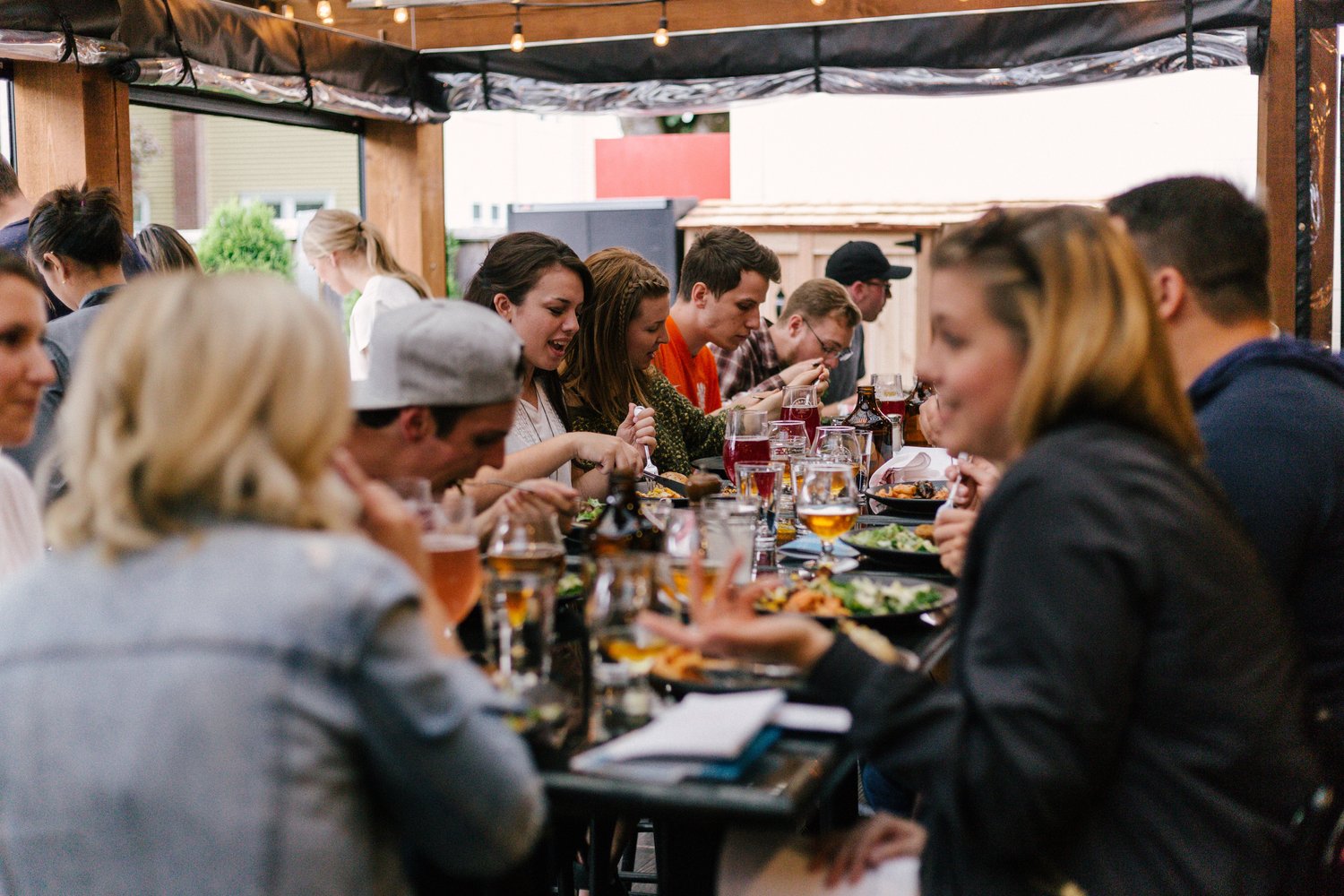 a table full of people eating and talking