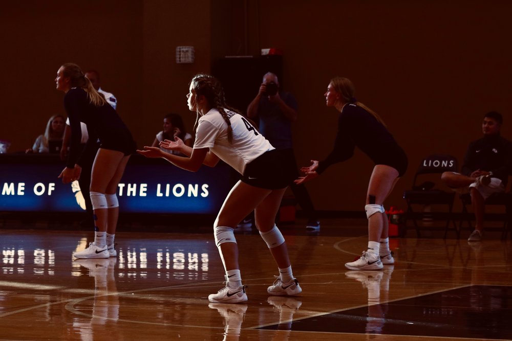 Women playing volleyball indoors