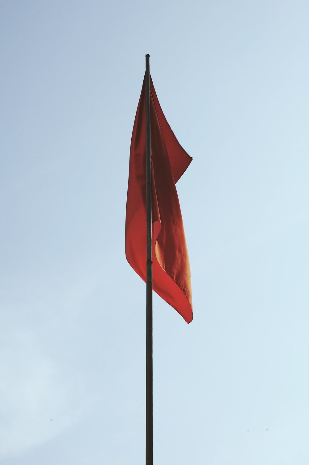 a red flag on a flagpole