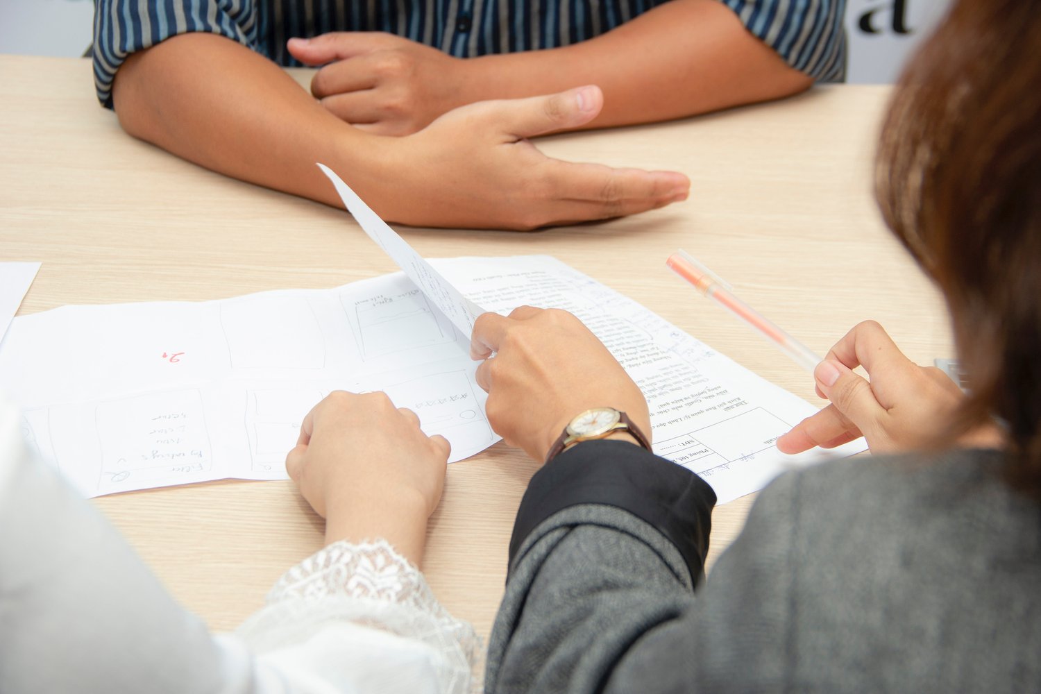 a group of three people working on a paper project together