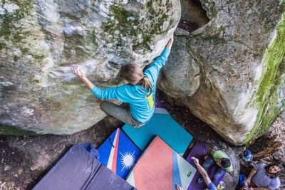 An above-view of someone climbing a rock outdoors