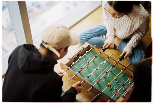 Students playing foosball 