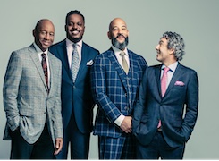The members of the Branford Marsalis Quartet posing and smiling