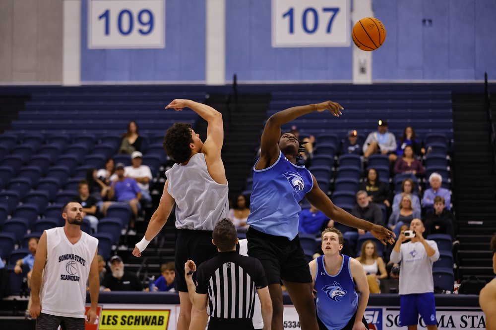 a player from Sonoma State's Men's Basketball team fighting for the rebound