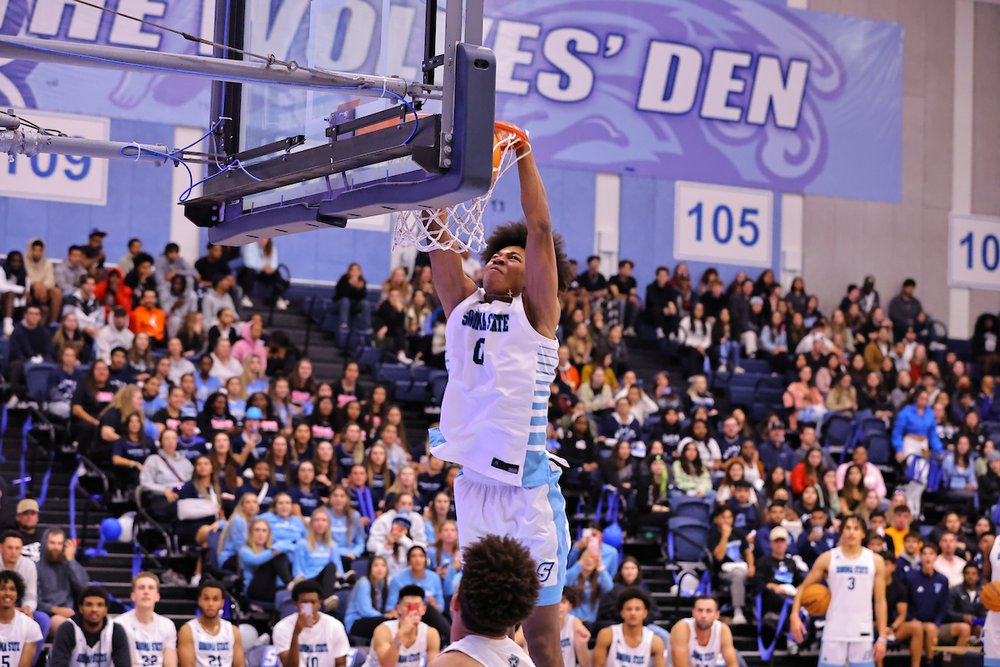 a member of SSU Men's Basketball team making a slam dunk during a basketball game