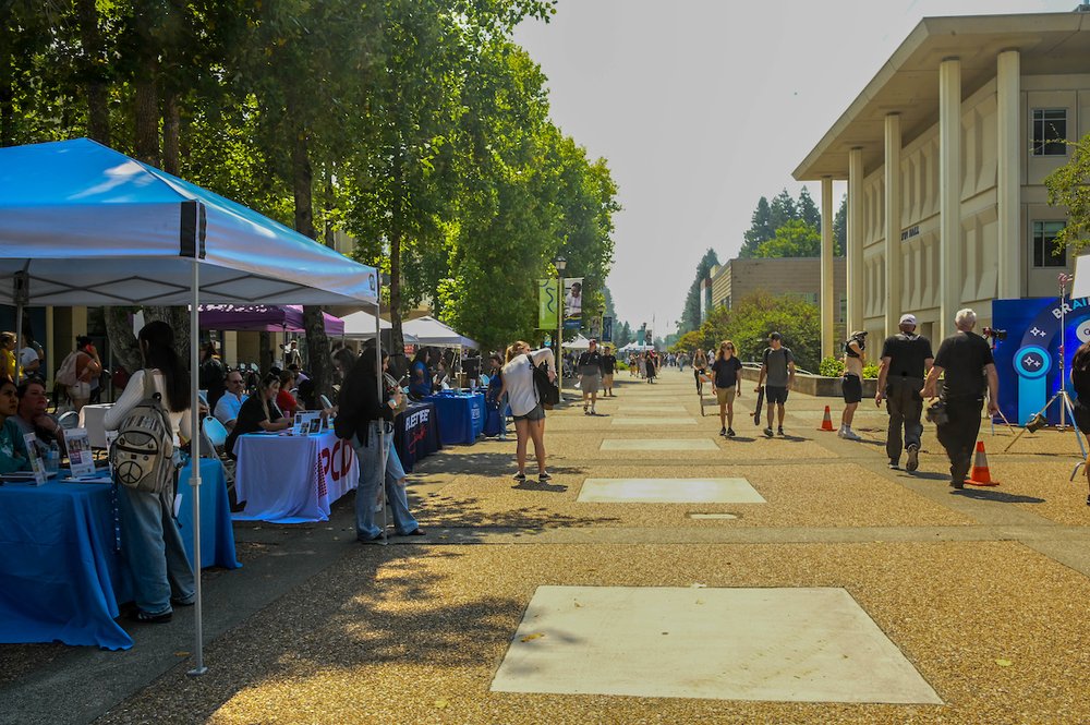 a student fair with booths between Salazar Hall and Darwin Hall