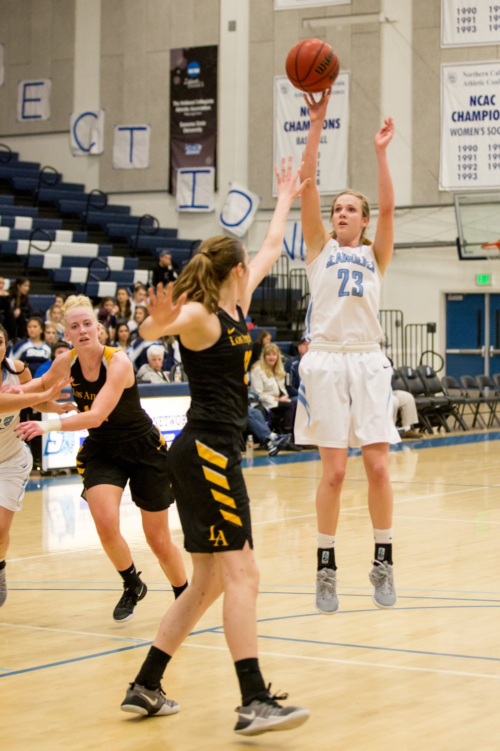 a player from Sonoma State's Women's Basketball team shooting the basketball for the hoop during a game