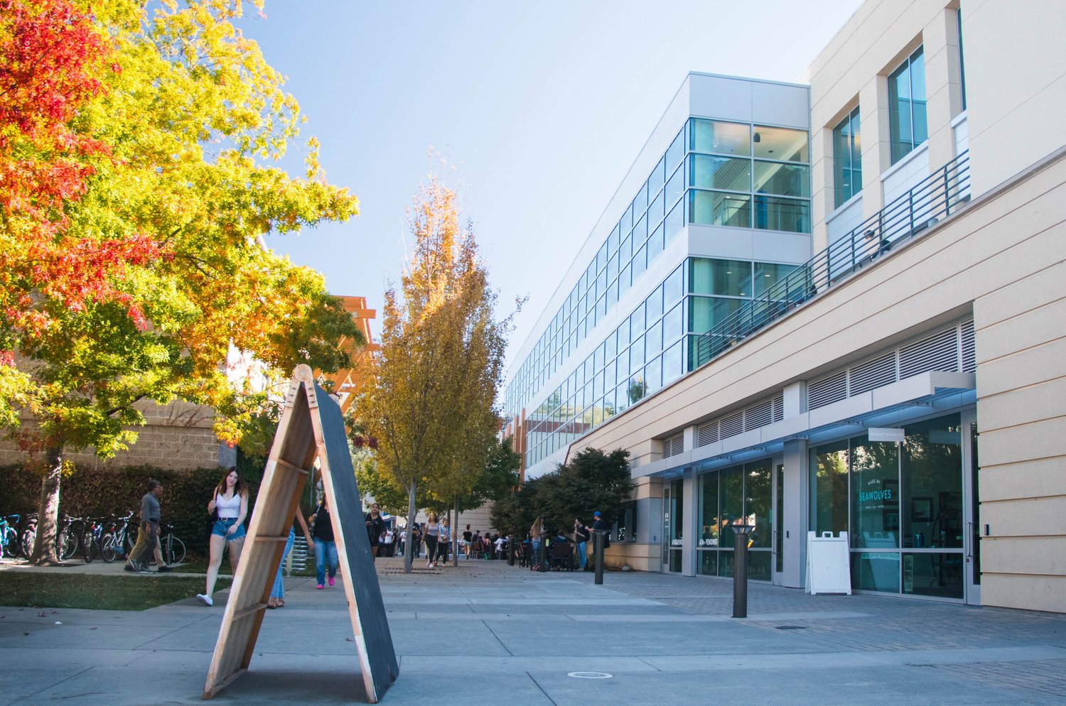 An A-frame sign and colorful trees outside of the Student Center 