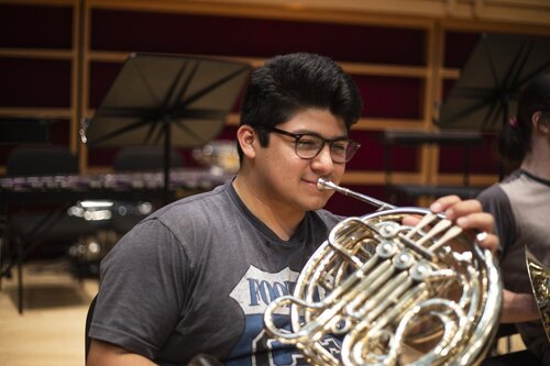 Student playing an instrument 