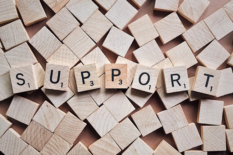 Scrabble pieces spelling out the word "Support"