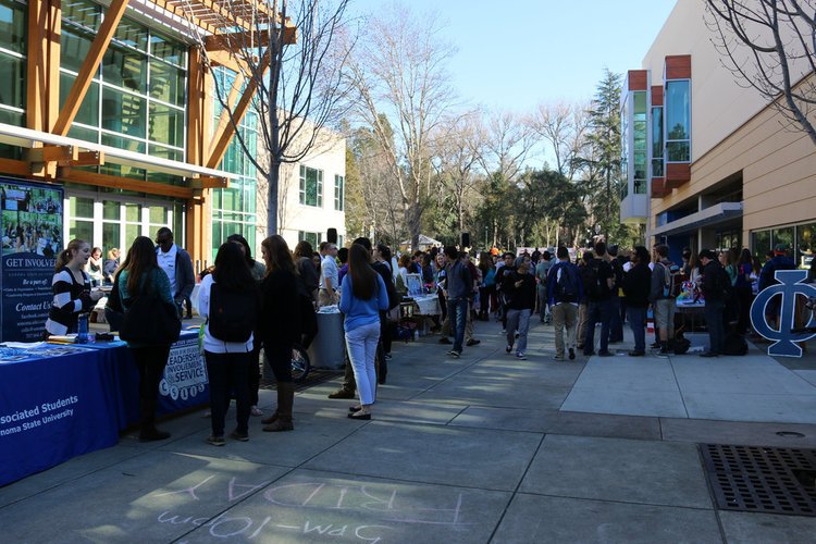 Students engaging with clubs and organizations tabling in Seawolf Plaza