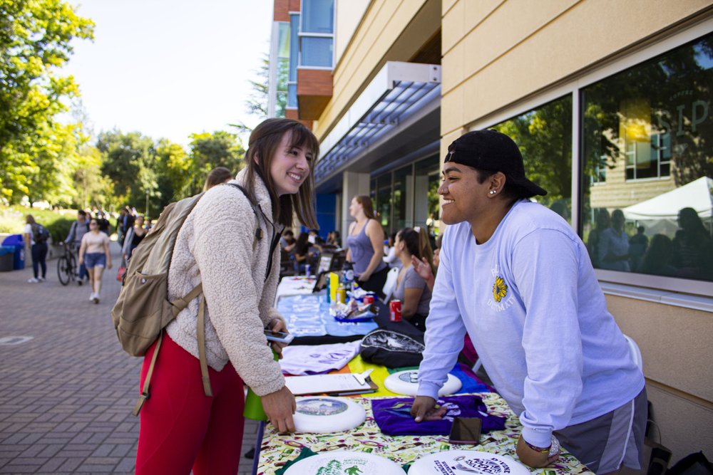 students tabling and talking to other students in Seawolf Plaza