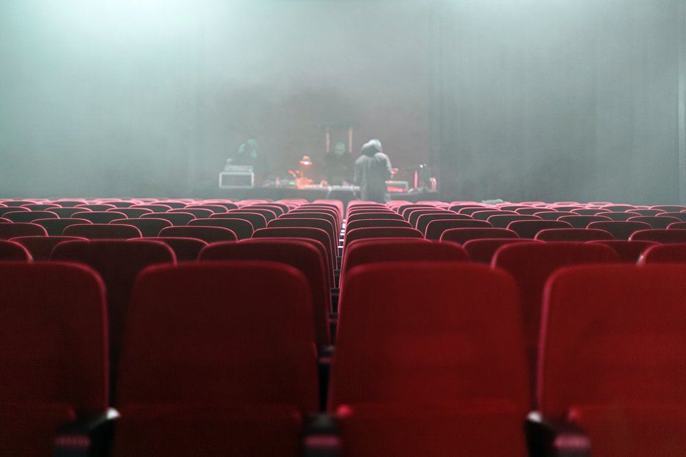 red theatre seats with a view of the stage