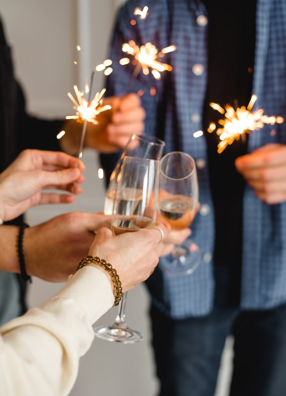 people clinking champagne flutes together