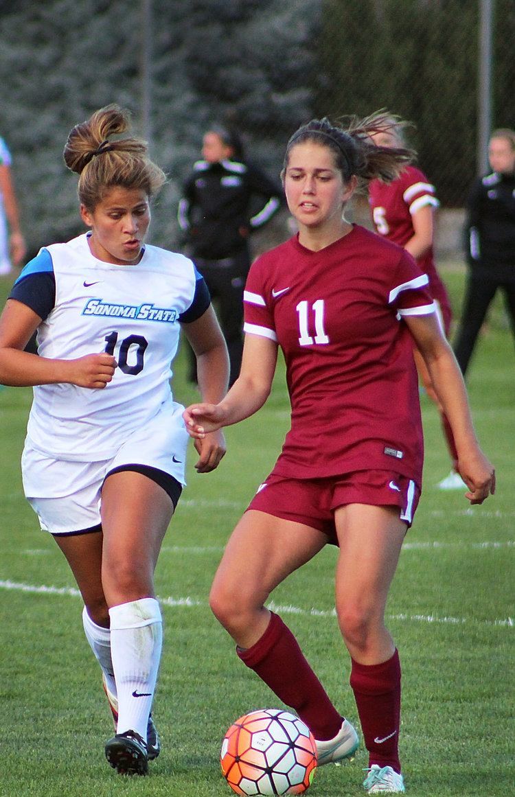 Two women playing soccer