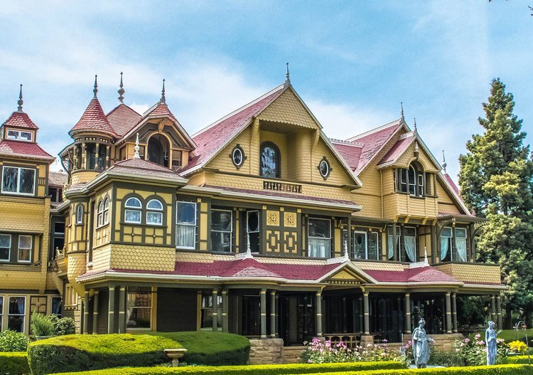 The Winchester Mystery House with clouds in the background