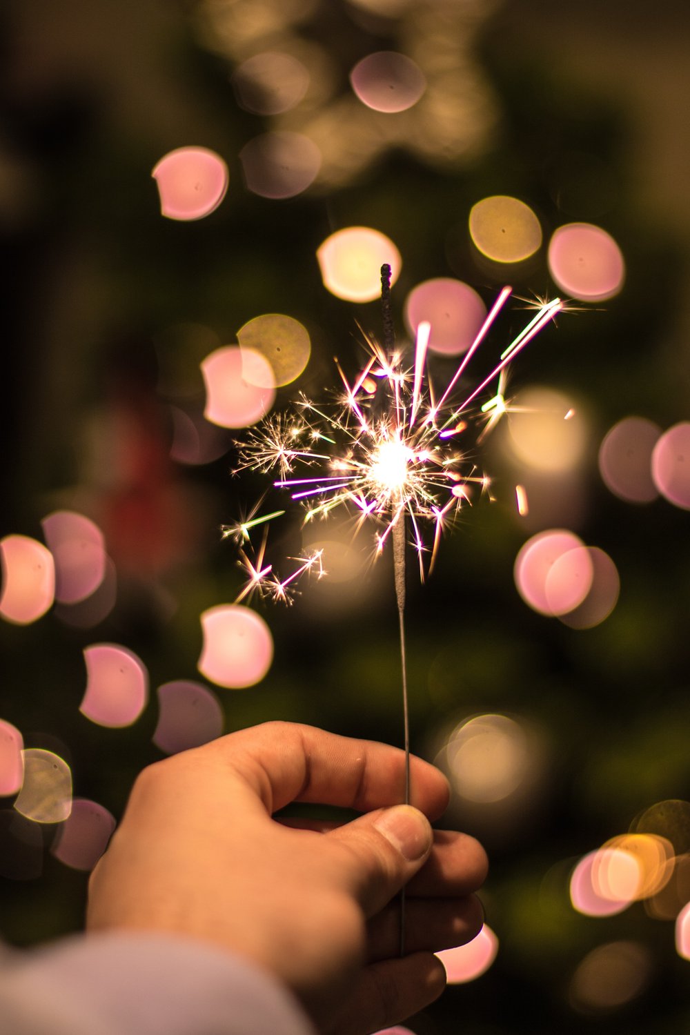 Someone holding a colorful sparkler 