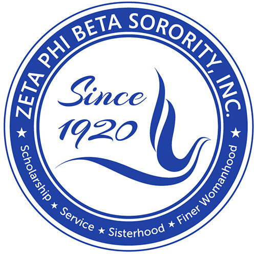 The circular Zeta Phi Beta Sorority logo featuring the words 'Zeta Phi Beta Sorority - Scholarship - Service - Sisterhood - Finer Womanhood - Since 1920' in blue and white