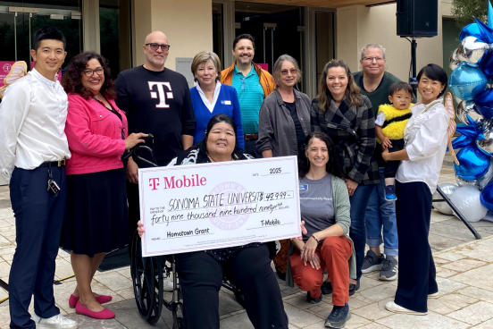 People in a group holding al arge check for Sonoma State for $49,999.00 from T-Mobile