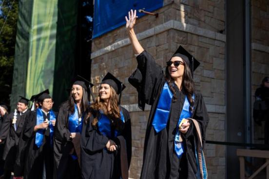 SSU students waving will graduating at Commencement