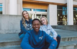 Students posing and smiling while wearing SSU merch