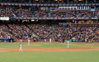 A baseball game in a large filled stadium