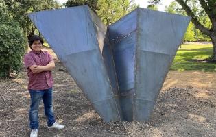 Student with metal sculpture