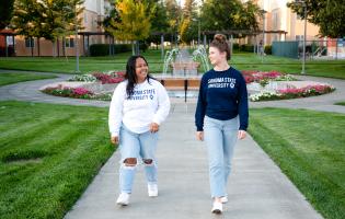 Two SSU students walking and laughing together 