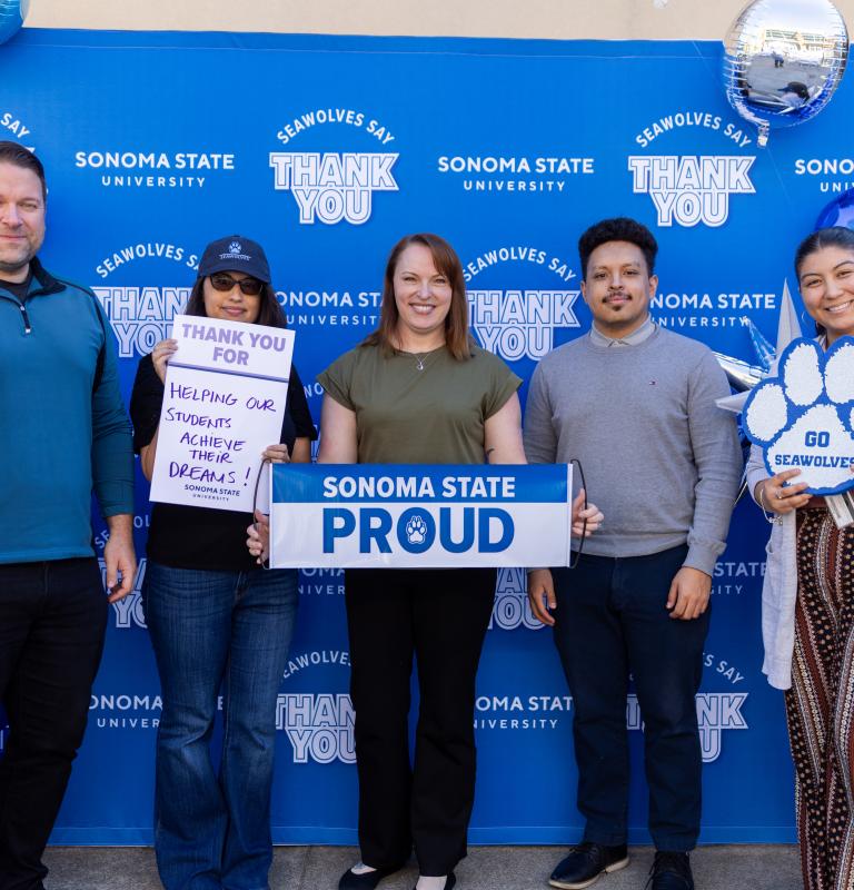 Group of employees holding Sonoma State Proud sign