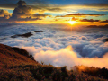 Colorful clouds rolling over hills during sunset or sunrise 