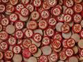 A pile of red BINGO coins with numbers on them 