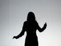 Black and white photo of the silhouette of someone dancing 