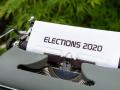 A grey typewriter with paper with text on it that reads "Elections 2020"