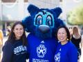 Judy K. Sakaki and Lobo greet new student to campus