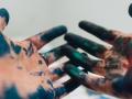 a pair of hands covered in paint